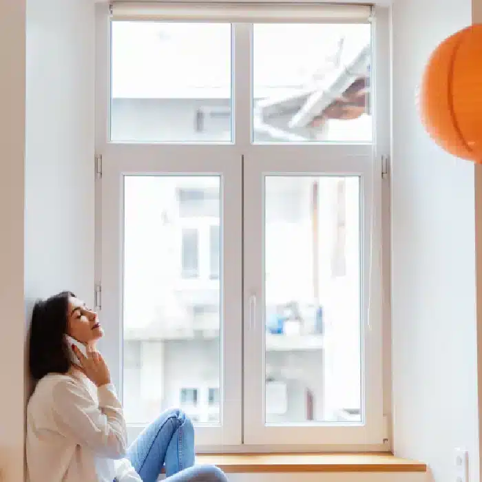 Woman relaxing by smart glass windows