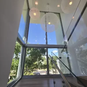 Custom window tint Miami installation transitioning from clear to frosted glass instantly.